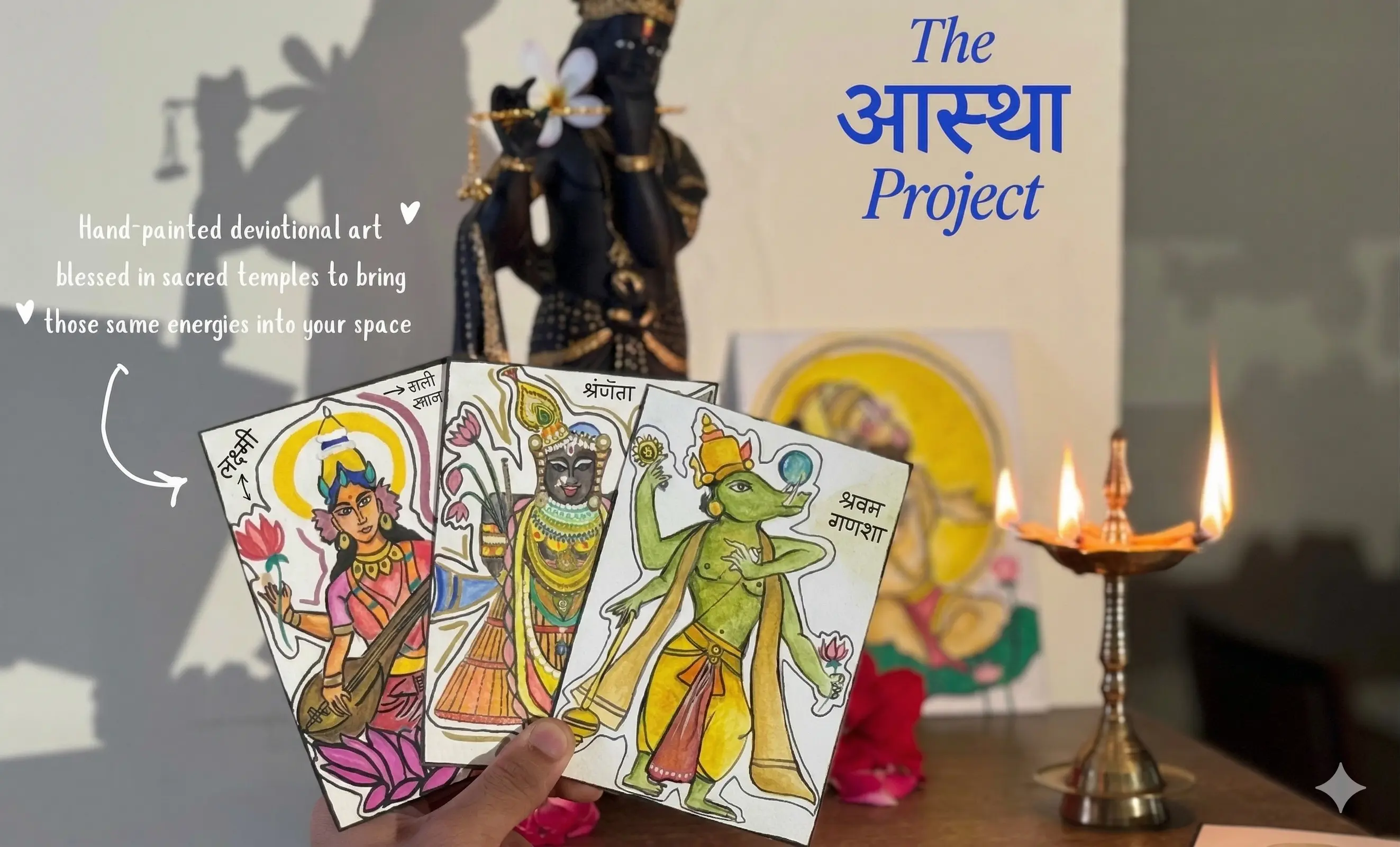 The Aastha Project devotional cards beside a diya